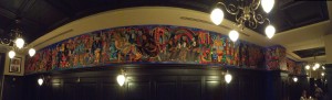 „Die Welt des Bruder August“. Acryl auf Leinwand, (16 Meter lang, 1 Meter hoch) für das Restaurant „Augustiner am Gendarmenmarkt“ in Berlin